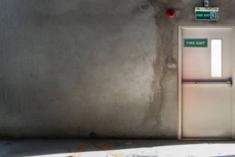 What is the minimum time an NHS fire door will contain fire smoke and toxic fumes