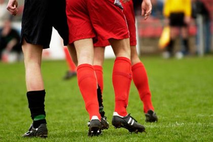 Why Do Footballers Cut Holes in Their Socks