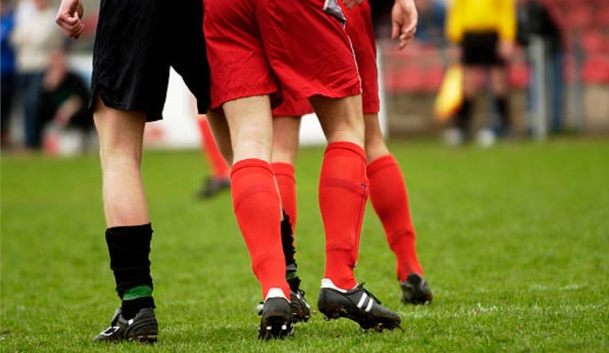 Why Do Footballers Cut Holes in Their Socks