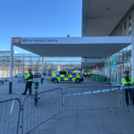 Police presence outside Milton Keynes Central station following a fatal shooting involving an armed suspect.