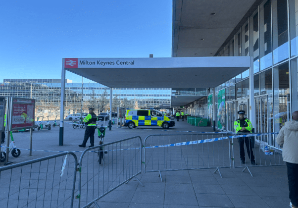 Police presence outside Milton Keynes Central station following a fatal shooting involving an armed suspect.