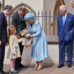 Queen Camilla wearing a pale blue coat dress and rose-trimmed hat, attending the Easter Matins Service at St George’s Chapel, Windsor.