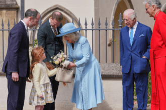 Queen Camilla wearing a pale blue coat dress and rose-trimmed hat, attending the Easter Matins Service at St George’s Chapel, Windsor.