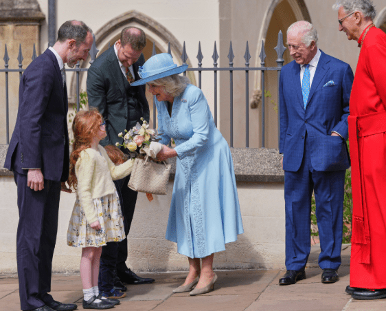 Queen Camilla wearing a pale blue coat dress and rose-trimmed hat, attending the Easter Matins Service at St George’s Chapel, Windsor.