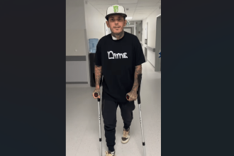 Tai Woffinden walking with crutches in a hospital corridor, starting rehabilitation following his speedway crash in Poland.