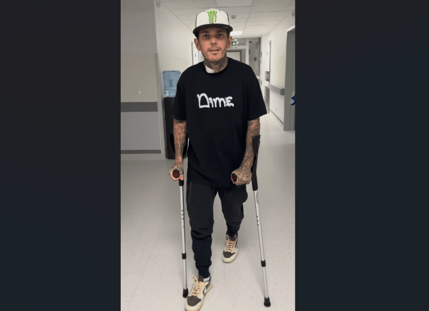 Tai Woffinden walking with crutches in a hospital corridor, starting rehabilitation following his speedway crash in Poland.