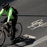 Cyclist Riding on Urban Road