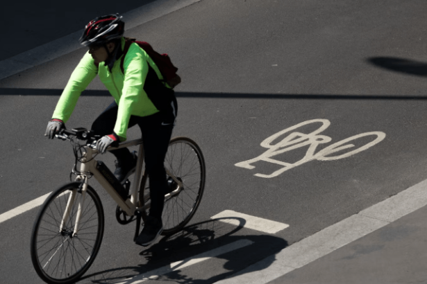 Cyclist Riding on Urban Road