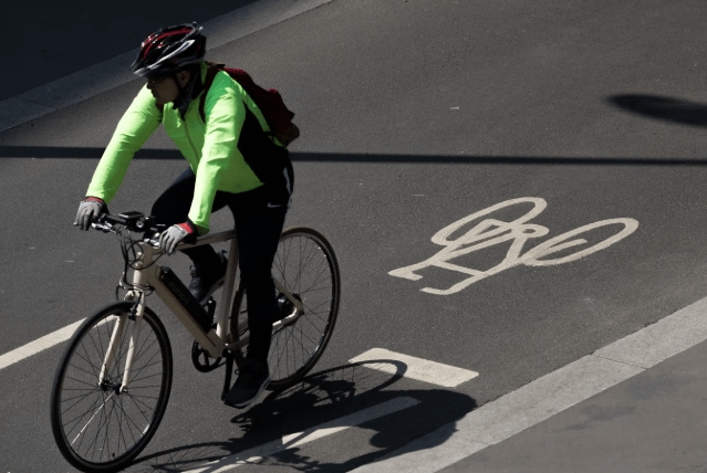Cyclist Riding on Urban Road